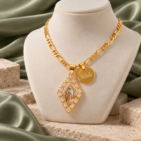 Gold diamond-shaped Virgin Mary necklace with name disc displayed on a jewelry bust